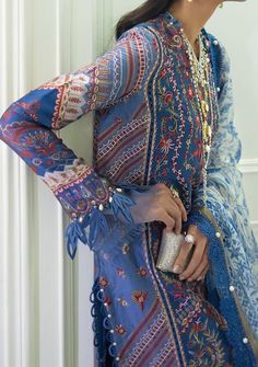 A multi-color Mughal Resham with an exquisite flower pattern on a French blue base and a delicately embroidered side kali. This style comes with a pair of pants and a beautiful ethnic chintz digitally printed dupatta in monotones of French blue. A great statement piece that will keep you looking stylish throughout the season. Shirt Front Center Panel Dyed & Embroidered on Lawn Shirt Side Kali Dyed & Embroidered on Lawn (Right) Shirt Side Kali Dyed & Embroidered on Lawn (Left) Back Plain Dyed on Blue Bohemian Unstitched Dress, Festive Dabka Work Tunic Dress, Unstitched Bohemian Dress With Resham Embroidery, Bohemian Blue Lawn Suit For Festive Occasions, Elegant Multicolor Tunic Kurta, Blue Bohemian Lawn Suit For Festive Occasion, Festive Tunic Dress With Dabka Work, Long Sleeve Summer Dress With Dabka Work, Summer Long Sleeve Dress With Dabka Work