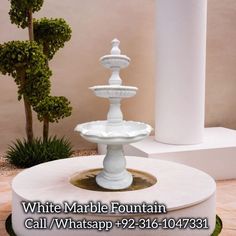 a white marble fountain sitting on top of a table