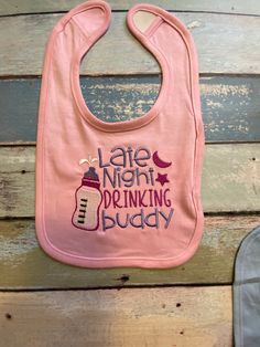 Great way to give mom or dad a little laugh while doing those middle of the night feedings. Our late night drinking buddy bib comes in pink or blue or white.  Hey. Spit and mess happens so let this bib catch it all! Beautifully embroidered on a standard infant bib and sealed with Soft cotton on the back so none of the stitching hits the babys tender skin. All bibs are made to order. Bib is Machine Embroidered with "Late Night Drinking Buddy" Fabric:  5.5 oz., 100% combed ringspun cotton premium jersey  Heather is 95/5 combed ringspun cotton/polyester White is sewn with 100% cotton thread Size:  7.5" Wide x 7" Long Features:  hook and loop closure EasyTear™ label CPSIA compliant tracking lable in side seam Machine washable/ tumble dry low Fit: Infant Unisex I also do custom baby shirts and Cricut Bibs, Cricut Baby Bibs, Funny Baby Bibs, Newborn Bibs, Cricut Baby, Drinking Buddies, Girls Bib, Baby Shower Gifts For Boys, Funny Baby Onesies