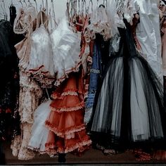 there are many dresses hanging on the clothes rack