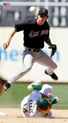 a baseball player is sliding into the base