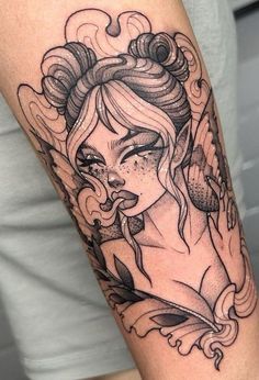 a woman's arm with a tattoo on it and an angel above her head