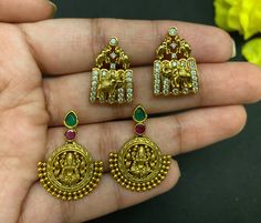 Gorgeous antique gold plated kempu CZ stone lakshmi and beautiful elephant studs earrings. Statement South Indian Style stud Earrings. These beautiful earrings come with kempu, white and green CZ stones, studded pearl. A gorgeous choice for any simple traditional outfit. Item size: Design 1: 2.9 cm length and 2 cm width approximately  Design 2: 2.1 cm length and 1.4 cm width approximately Closure: Pushback Ready to ship from FL USA Care: We don't want your special moments to fade. To maintain the quality of your jewelry, please => It is recommended to keep all your jewelry in Air-tight Bags to keep them intact for years to come. => Do not wear it to the pool, spa, or the beach. => Remove when sleeping, exercising, or doing other physically strenuous activities. Help: => We can add a gift c Temple Jewelry Brass Jhumkas As Gift, Bollywood Pendant Earrings As Gift, Bollywood Style Pendant Earrings As Gift, Brass Earrings For Diwali Gift, Hand Set Pendant Earrings For Festivals, Brass Jhumkas Gift For Diwali, Brass Jhumkas For Diwali Gift, Temple Jewelry Jhumkas As A Gift, Gift Temple Jewelry Jhumkas