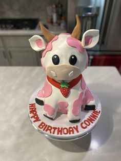 a birthday cake shaped like a cow sitting on top of a counter