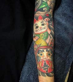 a person with a cat tattoo on their arm