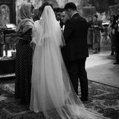 a bride and groom standing in front of the alter at their wedding ceremony with guests looking on