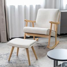 a rocking chair and foot stool in a living room