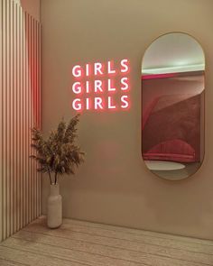 there is a pink neon sign that says girls, girls, girls on the wall