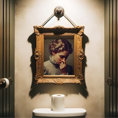 a bathroom with a painting on the wall next to a roll of toilet paper in front of it