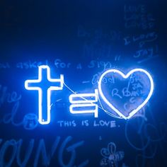 a blue neon sign with a cross and heart on it