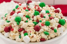 a white bowl filled with popcorn and candy