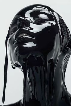 a woman's face covered in black liquid