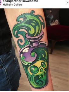 a woman with a green and purple tattoo on her arm is holding a glass bottle