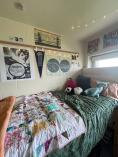 there is a bed in the room with many pictures on the wall and lights above it