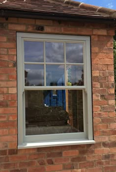 a brick building with a white window on the side