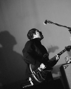 a man that is standing up with a guitar