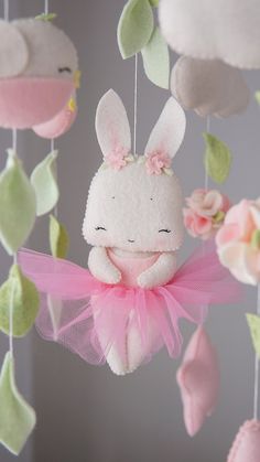 a stuffed animal hanging from a string in the shape of a bunny with pink tutu