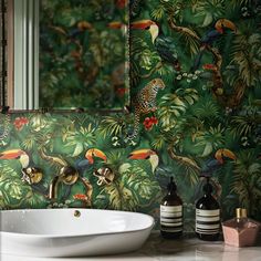 a bathroom sink sitting under a mirror next to a green wall