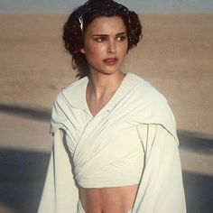 a woman in a white dress on the beach