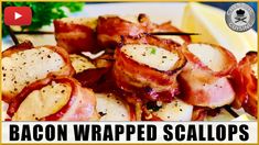 bacon wrapped scallops on a plate with lemon wedges