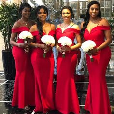 the bridesmaids are all wearing red dresses with white bouquets in their hands