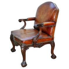 an old fashioned leather chair with wood trimmings on the arm and backrest