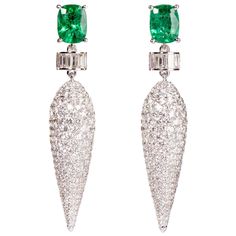 Icicle motif dangler earrings with unenhanced emerald and round brilliant diamonds. This dramatic earring features an icicle of pave diamonds hanging from the ear that dazzles with its stunning play of light. The captivating earrings boldly blend pure geometric motifs with stunning natural forms. Designed by Ri Noor, the earrings express the brand's sense of brilliance and originality. Each piece starts with a passion for gems and discovering the beauty found in the irregularity and imperfection Diamond Danglers, Round Cut Diamond Earrings, Dramatic Earrings, Dangler Earrings, Sparkle Earrings, Diamond Drop Earrings, Trendy Earrings, Diamond Drops, Emerald Jewelry