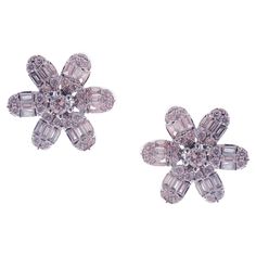 These classic flower stud earrings with round and baguette white diamonds are crafted in 18-karat white gold, featuring 50 round white diamonds totaling of 0.59 carats and 36 baguette white diamonds totaling of 0.39 carats. These earrings come with push back post backings. VS-G Quality white diamonds. Diamond Flower, Flower Earrings Studs, Flower Studs, Gems Jewelry, Baguette Diamond, Diamond White, Jewelry Earrings Studs, Floral Rings, Gems