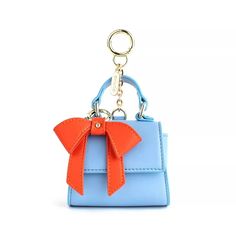 We know how much you love our classic Cottontail bag so we “honey I shrunk it! Scoop up this cute mini version and use it as a bag charm or a keychain or both. Large enough to hold your AirPods, keys, or small change, the Cottontail mini is sure to steal your heart while keeping your belongings secure with its magnetic closure. We even made its bow removable! So buy it in as many colors as you like and swap the bows to customize. 

Dimensions:
3.75W x 5.25H x 2.25D Bag Keychain, Orange Bows, Vegan Leather Bag, Classic Bags, Black Leather Bags, Mini Fashion, Cute Bag, Magnetic Closure, Handbag Accessories