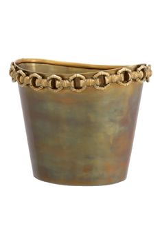 a gold colored pot with chains on the rim and bottom, sitting in front of a white background