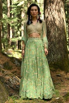 Fern green tiered lehenga with bagh print, moti, dabka work, sequins and zari embroidery. Comes with sleeveless blouse, scallop dupatta and cutdana belt.
Component: 4
Pattern: Print and Embroidery
Type Of Work: Bagh Print,  Moti, Dabka Work, Sequins, Cutdana and Zari
Neckline: V neck
Sleeve Type: Sleeveless
Fabric: Lehenga: Georgette, Blouse: Crepe and Dupatta: Tissue 
Color: Green
Other Details: 
Embroidered dupatta with scallop border
Back with tie and tassels
Padded blouse
Occasion: Sangeet - Anarkali Green Lehenga With Sequins, Green Sharara With Intricate Embroidery For Party, Party Sharara In Green With Intricate Embroidery, Green Palazzo Set With Intricate Embroidery For Party, Green Embroidered Palazzo Set For Party, Embellished Green Lehenga For Festive Occasions, Party Green Sharara With Intricate Embroidery, Green Sequined Palazzo Set For Eid, Festive Green Embellished Lehenga