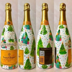 three bottles of champagne with christmas trees on them