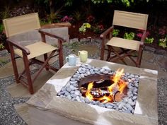 an outdoor fire pit with chairs around it and the fire is blazing up in the middle