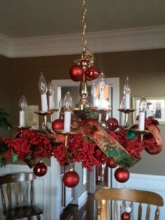 a chandelier with christmas decorations hanging from it