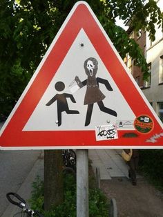 a street sign that has been vandalized with stickers on it's side