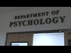 the department of psychology sign is on the wall above an open door