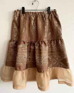 Gorgeous brown and copper Navajo handmade skirt made by Navajo artist Racheal Cooley  Has a very comfortable and flexible waistband that will fit like a Medium/Large Very beautiful and flowy  One of a kind, every piece is handmade no two pieces are the same.  By purchasing this item you are supporting a Native American owned small business that supports Native Artists of all ages and all tribes. **Custom skirts available please message us if that's something you're looking for!  Free Shipping Navajo Traditional Skirts, Custom Skirts, Bohemian Brown Cotton Skirt, Golden Harvest, Handmade Skirts, Kissimmee, Two Pieces, Native American, Womens Skirt