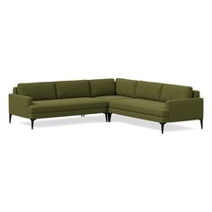 a green sectional couch with black legs