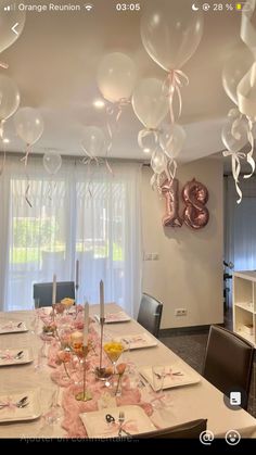 the table is set with balloons, plates and utensils for an elegant celebration