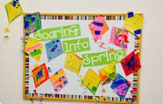 a bulletin board with colorful papers on it and the words soaring into spring written in green