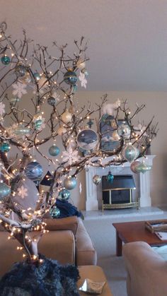 a living room filled with furniture and a christmas tree in the middle of the room