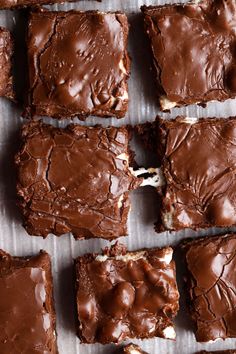 chocolate brownies cut into squares on top of a piece of parchment paper