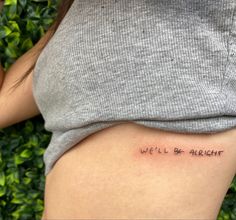 a woman's stomach with the words well be alright tattooed on her left side