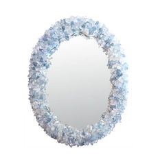 a round mirror with blue flowers around it