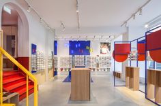 the inside of a store with shelves and red, yellow, blue and white items