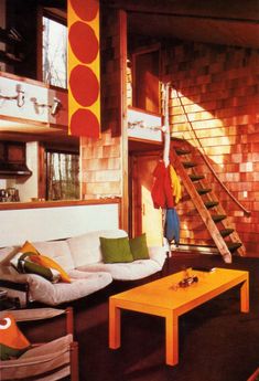 a living room filled with furniture and a staircase