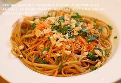 a white plate topped with noodles and carrots covered in parmesan sprinkles