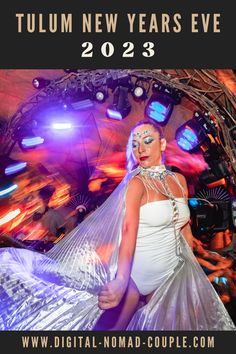 a woman in a white dress standing next to a stage with lights on it and the words tulm new years eve 2012