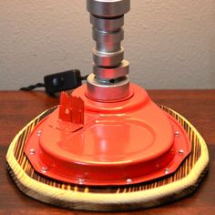 a red object sitting on top of a wooden table