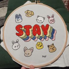 someone is holding up a cross - stitch hoop with the word stay written in it